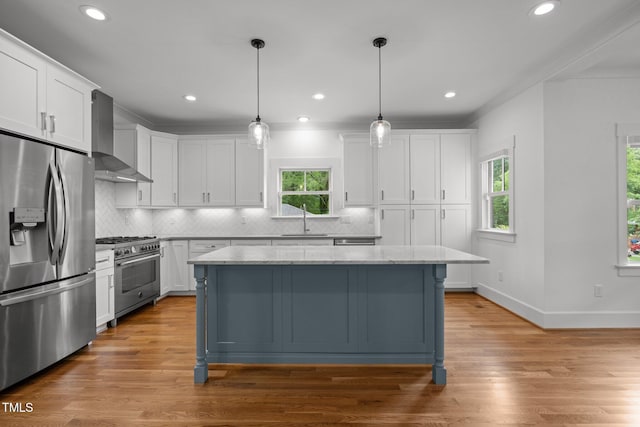 2551 Drake Ave, Durham, NC 27705 - kitchen featuring stainless steel appliances, wall chimney exhaust hood, white cabinets, a kitchen island, and recessed lighting