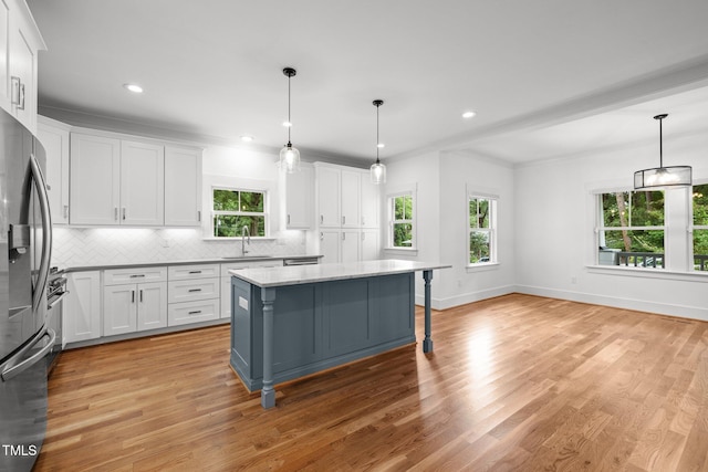 2551 Drake Ave, Durham, NC 27705 - kitchen featuring stainless steel fridge with ice dispenser, backsplash, plenty of natural light, white cabinets, and recessed lighting