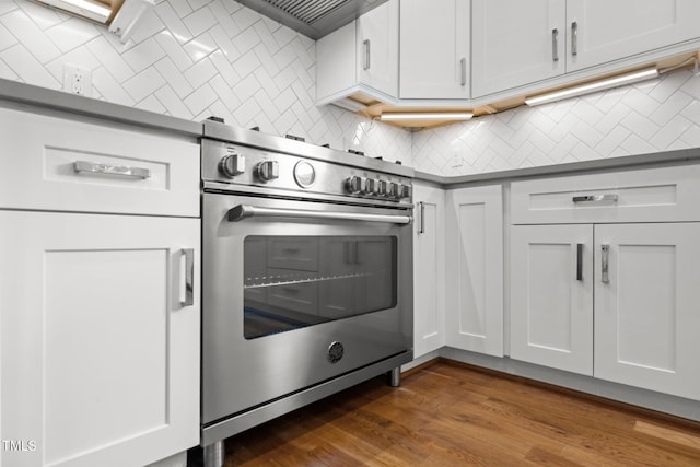 2551 Drake Ave, Durham, NC 27705 - kitchen with high end stainless steel range oven, decorative backsplash, dark wood-type flooring, and white cabinets