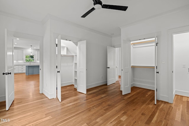 2551 Drake Ave, Durham, NC 27705 - unfurnished bedroom with light wood-style floors, ornamental molding, a walk in closet, and ceiling fan