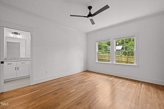 2551 Drake Ave, Durham, NC 27705 - unfurnished bedroom with light wood-style floors, connected bathroom, a ceiling fan, and ornamental molding
