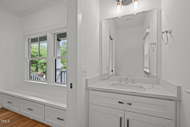 2551 Drake Ave, Durham, NC 27705 - bathroom with vanity, wood finished floors, and crown molding