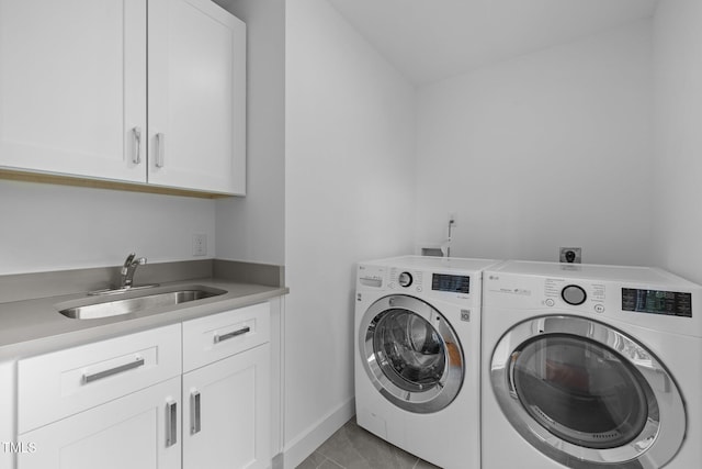 2551 Drake Ave, Durham, NC 27705 - laundry area with washing machine and clothes dryer, cabinet space, and light tile patterned flooring