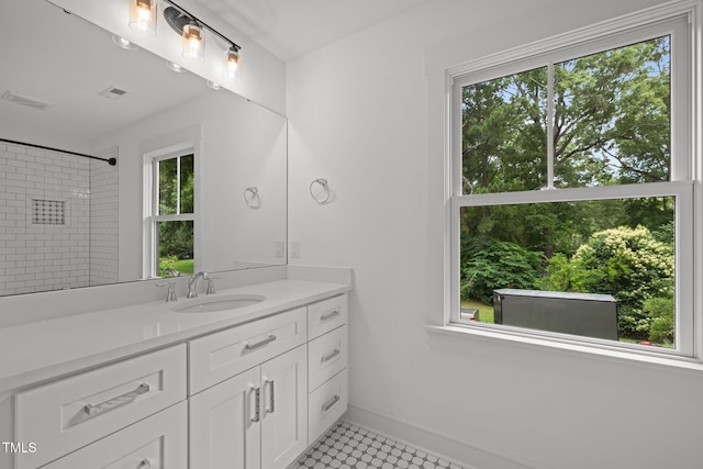 2551 Drake Ave, Durham, NC 27705 - bathroom with vanity, healthy amount of natural light, a shower, and tile patterned flooring