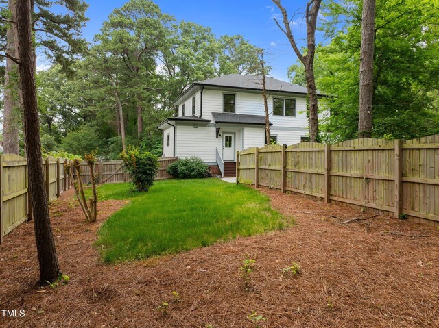 2551 Drake Ave, Durham, NC 27705 - back of house with a fenced backyard and roof with shingles