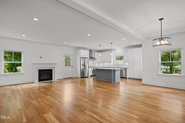 2551 Drake Ave, Durham, NC 27705 - unfurnished living room with recessed lighting, light wood-style floors, a premium fireplace, and a chandelier