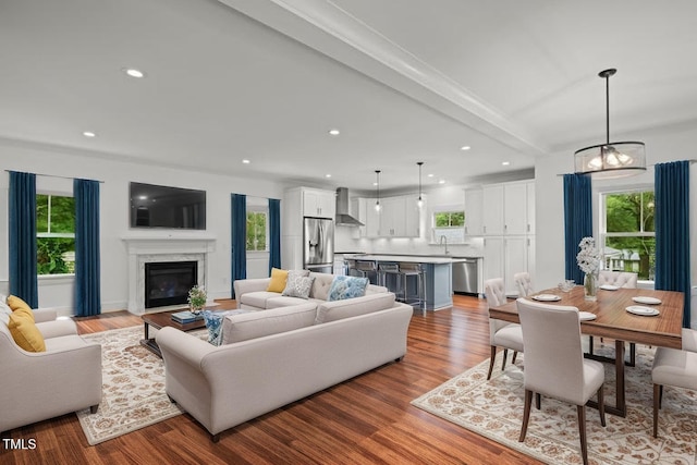 2551 Drake Ave, Durham, NC 27705 - living room featuring healthy amount of natural light, wood finished floors, a fireplace, and recessed lighting