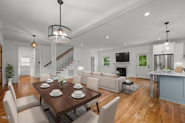 2551 Drake Ave, Durham, NC 27705 - dining room with stairs, recessed lighting, light wood-style floors, and a fireplace