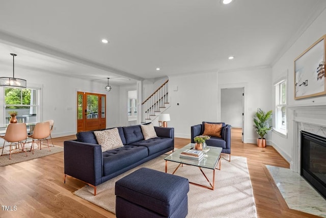 2551 Drake Ave, Durham, NC 27705 - living room featuring stairs, recessed lighting, a fireplace, and light wood-style floors
