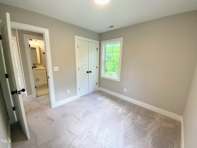 608A E Umstead, Durham, NC 27701 - unfurnished bedroom featuring light carpet and a closet