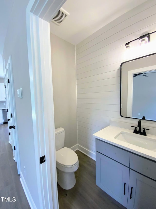 608A E Umstead, Durham, NC 27701 - half bathroom with wood walls, vanity, and wood finished floors