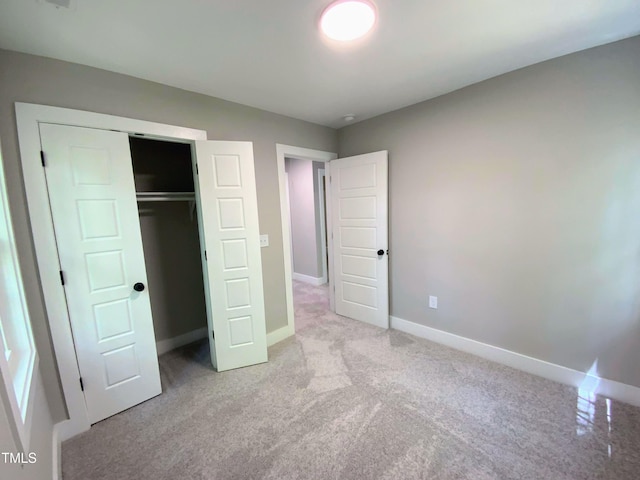 608A E Umstead, Durham, NC 27701 - unfurnished bedroom featuring light colored carpet and a closet