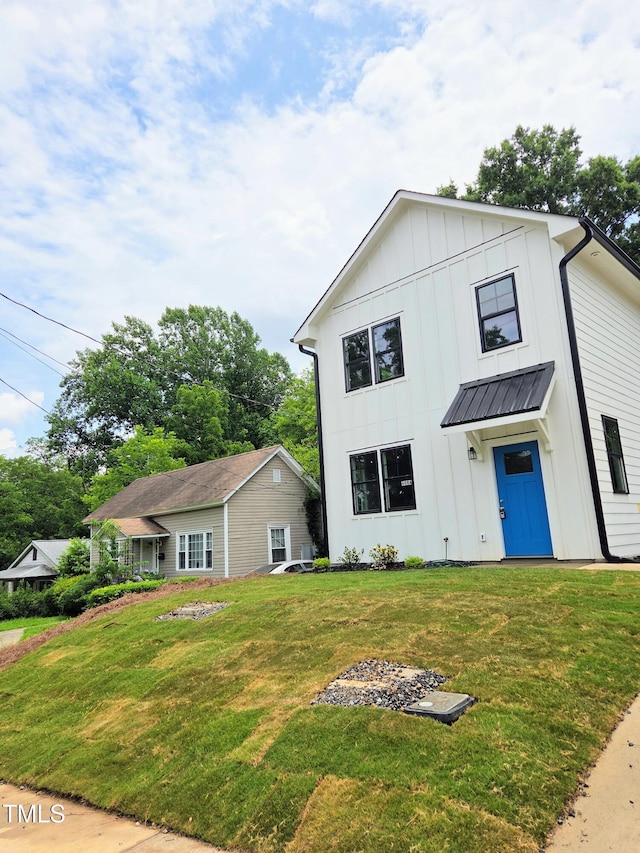 608A E Umstead, Durham, NC 27701 - view of front of house with board and batten siding and a front lawn