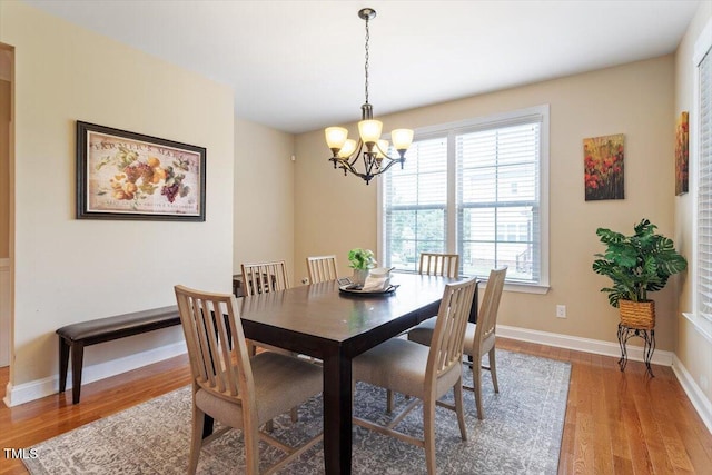 150 Saint Mellion St, Raleigh, NC 27603 - dining room with light wood-style flooring and a chandelier