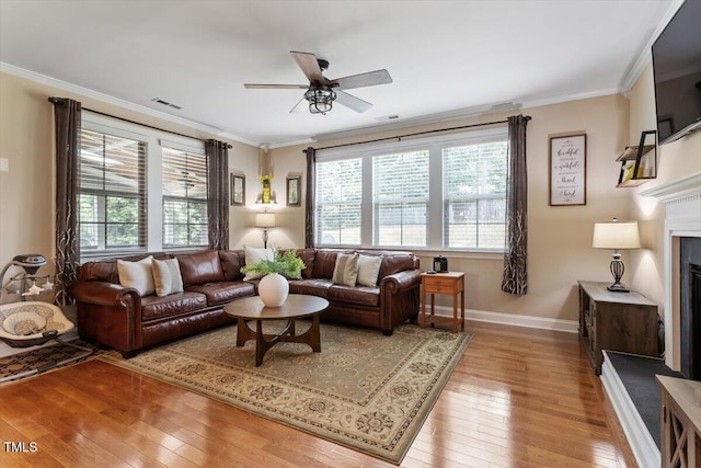 150 Saint Mellion St, Raleigh, NC 27603 - living room with hardwood / wood-style floors, a ceiling fan, ornamental molding, and a fireplace