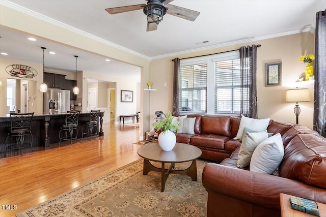 150 Saint Mellion St, Raleigh, NC 27603 - living room with light wood finished floors, a ceiling fan, healthy amount of natural light, ornamental molding, and recessed lighting
