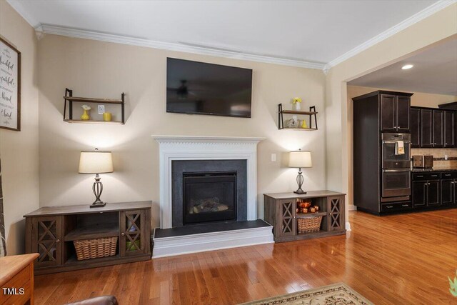 150 Saint Mellion St, Raleigh, NC 27603 - living area with ornamental molding, wood finished floors, and a glass covered fireplace
