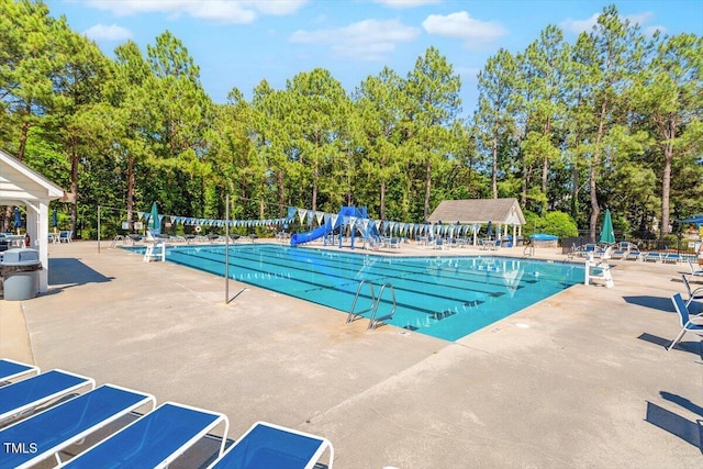 150 Saint Mellion St, Raleigh, NC 27603 - community pool featuring a patio and view of scattered trees