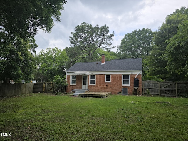 704 N King Charles Rd, Raleigh, NC 27610 - back of property featuring a fenced backyard, a gate, a chimney, and brick siding