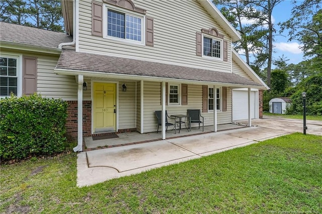 140 Bledsoe St, Hope Mills, NC 28348 - view of front facade featuring a porch, a front yard, driveway, brick siding, and a storage shed