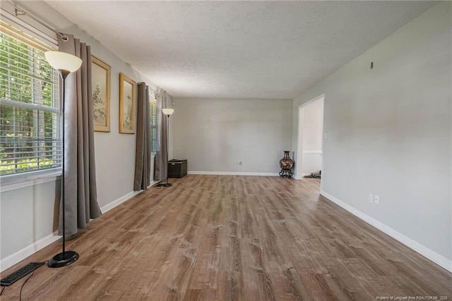 140 Bledsoe St, Hope Mills, NC 28348 - unfurnished living room with wood finished floors and a textured ceiling