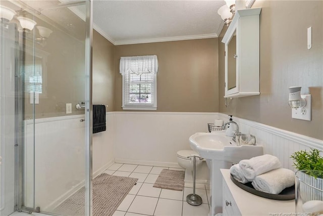 140 Bledsoe St, Hope Mills, NC 28348 - full bath with a shower stall, a wainscoted wall, ornamental molding, and tile patterned flooring