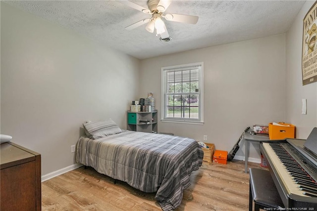 140 Bledsoe St, Hope Mills, NC 28348 - bedroom featuring light wood finished floors, a textured ceiling, and ceiling fan