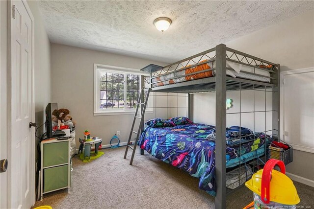 140 Bledsoe St, Hope Mills, NC 28348 - carpeted bedroom featuring a textured ceiling