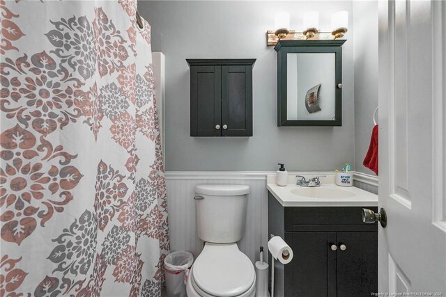 140 Bledsoe St, Hope Mills, NC 28348 - full bathroom with vanity, a wainscoted wall, and curtained shower