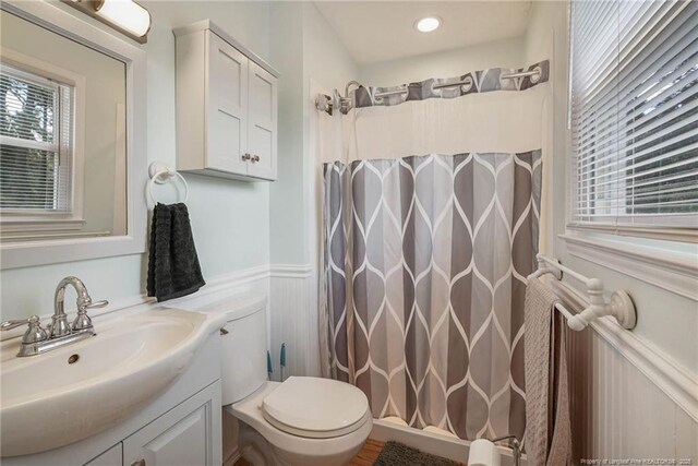 140 Bledsoe St, Hope Mills, NC 28348 - bathroom with vanity, wainscoting, a shower with shower curtain, and a decorative wall