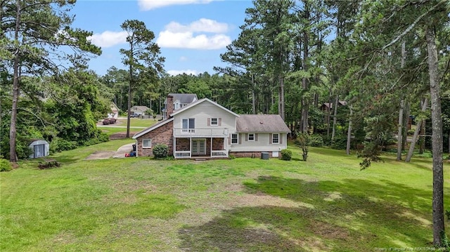 140 Bledsoe St, Hope Mills, NC 28348 - view of front of house featuring a front yard, a storage shed, french doors, and a chimney