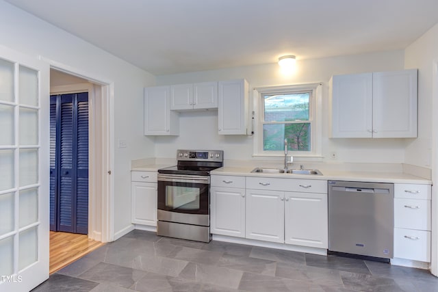 2009 Carolina Ave, Durham, NC 27705 - kitchen with appliances with stainless steel finishes, white cabinetry, and light countertops