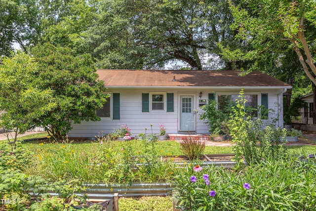 2009 Carolina Ave, Durham, NC 27705 - single story home featuring a vegetable garden and roof with shingles