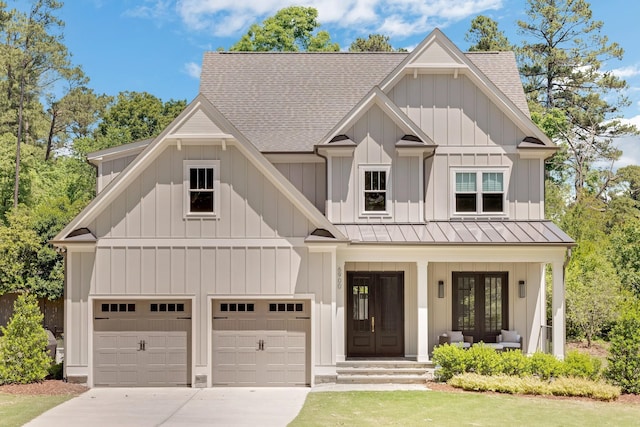 6900 Staghorn Ln, Raleigh, NC 27615 - view of front of house featuring roof with shingles, a standing seam roof, driveway, and french doors