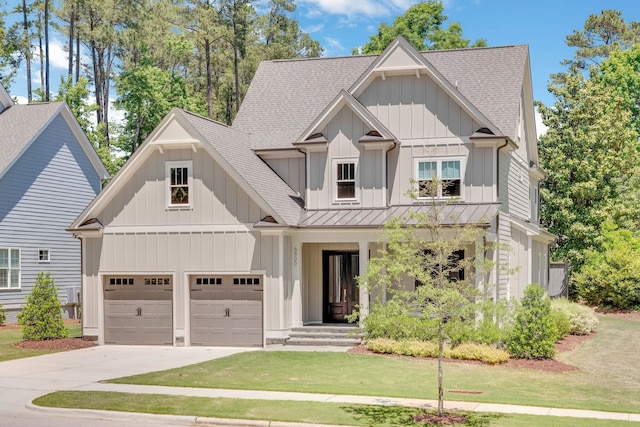 6900 Staghorn Ln, Raleigh, NC 27615 - view of front of property with a shingled roof, driveway, a standing seam roof, board and batten siding, and a front yard