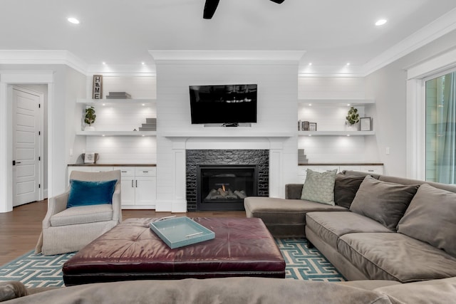 6900 Staghorn Ln, Raleigh, NC 27615 - living area with wood finished floors, crown molding, a ceiling fan, recessed lighting, and a glass covered fireplace