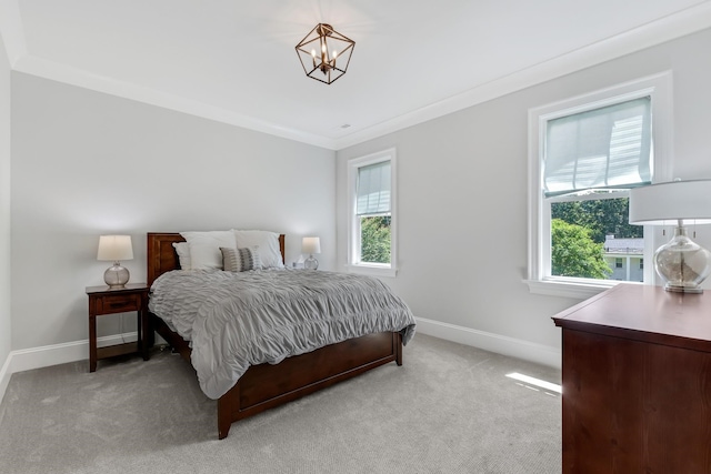 6900 Staghorn Ln, Raleigh, NC 27615 - bedroom featuring multiple windows, light colored carpet, crown molding, and a chandelier