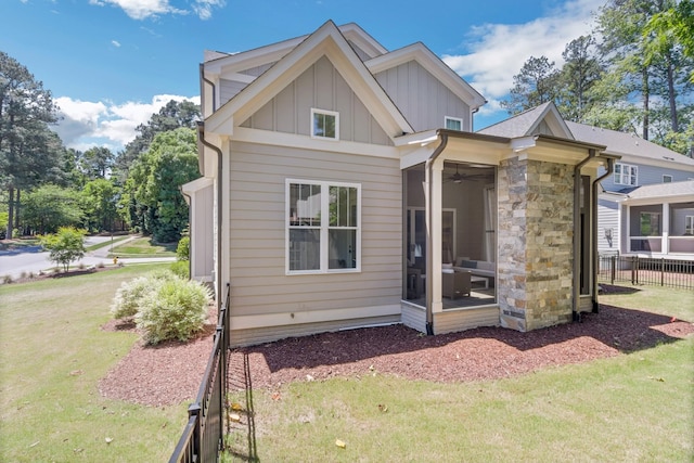6900 Staghorn Ln, Raleigh, NC 27615 - rear view of property with a sunroom, board and batten siding, and a ceiling fan