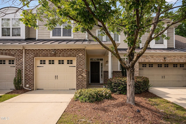 1016 Kingston Grove Dr, Cary, NC 27519 - multi unit property featuring brick siding, an attached garage, concrete driveway, and a standing seam roof