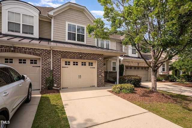 1016 Kingston Grove Dr, Cary, NC 27519 - multi unit property featuring brick siding, a standing seam roof, a garage, and driveway