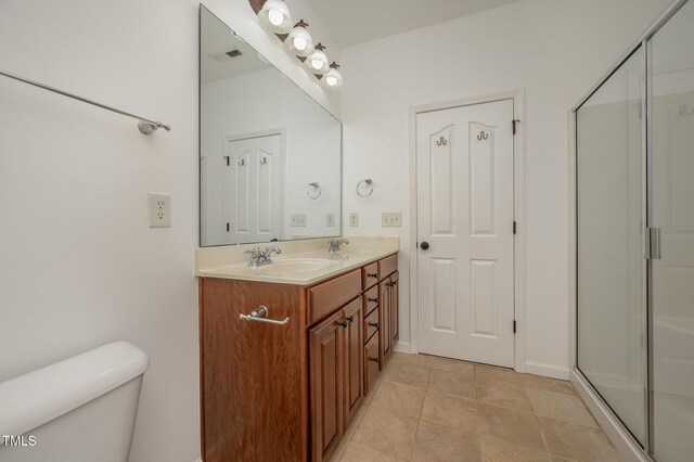 1016 Kingston Grove Dr, Cary, NC 27519 - bathroom with double vanity, tile patterned floors, and a shower with door