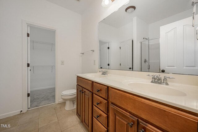 1016 Kingston Grove Dr, Cary, NC 27519 - full bath with a shower stall, double vanity, tile patterned flooring, and a walk in closet