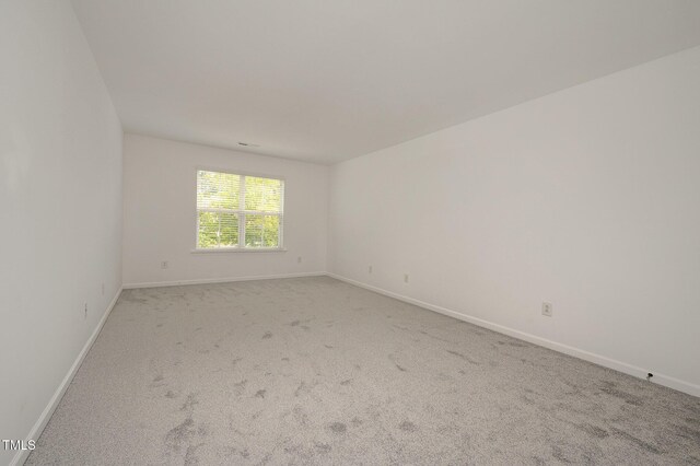 1016 Kingston Grove Dr, Cary, NC 27519 - carpeted empty room with baseboards