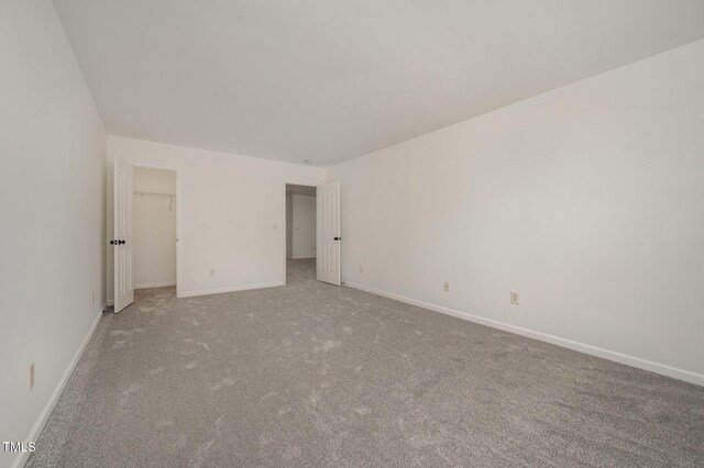 1016 Kingston Grove Dr, Cary, NC 27519 - unfurnished bedroom featuring carpet flooring and a spacious closet