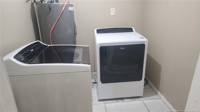 805 Perley St, Fayetteville, NC 28305 - laundry room featuring washing machine and clothes dryer, water heater, and marble finish flooring