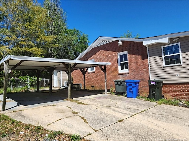 805 Perley St, Fayetteville, NC 28305 - view of side of property featuring driveway, a carport, and brick siding