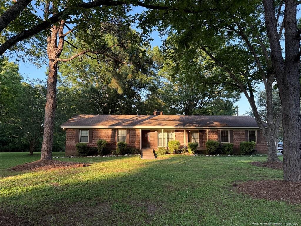 2732 Leaflet Church Rd, Broadway, NC 27505 - ranch-style house with a front lawn and brick siding