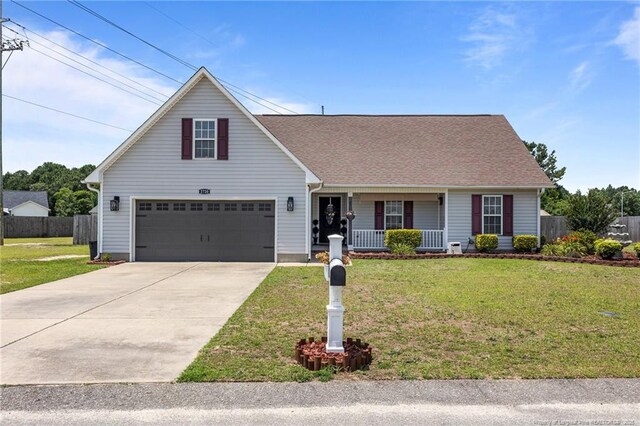 2720 Daniel Boone Ln, Hope Mills, NC 28348 - traditional home with a porch, a garage, driveway, and roof with shingles