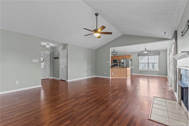 2720 Daniel Boone Ln, Hope Mills, NC 28348 - unfurnished living room with a fireplace, a ceiling fan, dark wood-style flooring, and vaulted ceiling