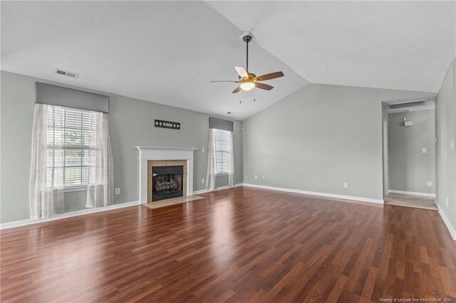 2720 Daniel Boone Ln, Hope Mills, NC 28348 - unfurnished living room featuring lofted ceiling, a ceiling fan, a tiled fireplace, and wood finished floors